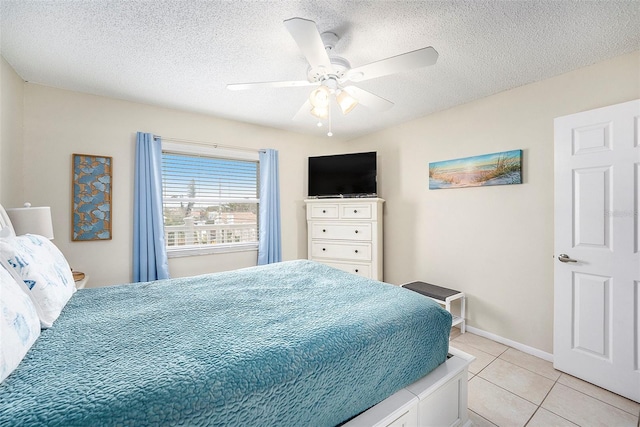 tiled bedroom with ceiling fan and a textured ceiling