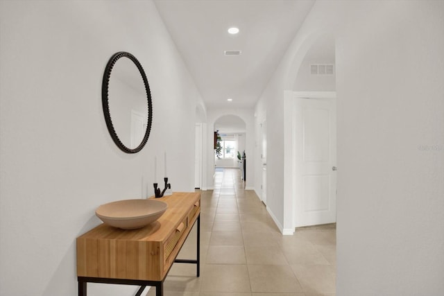 corridor featuring light tile patterned floors