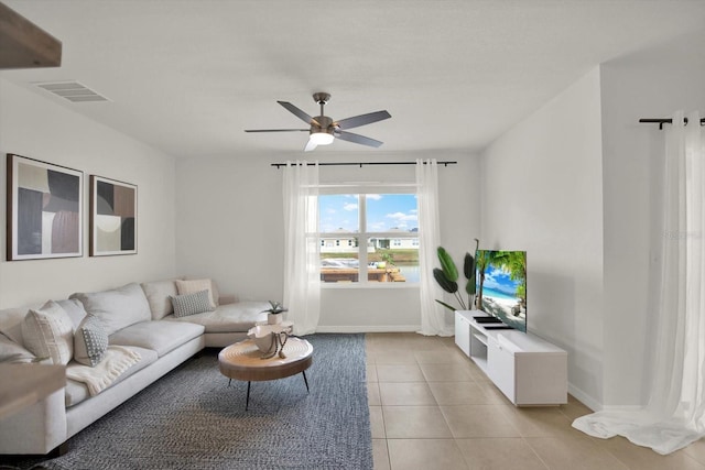 living room with ceiling fan and light tile patterned flooring