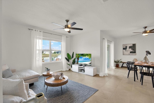 living room featuring ceiling fan and light tile patterned floors