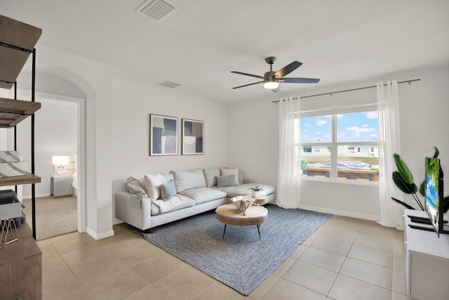 living room with light tile patterned floors and ceiling fan