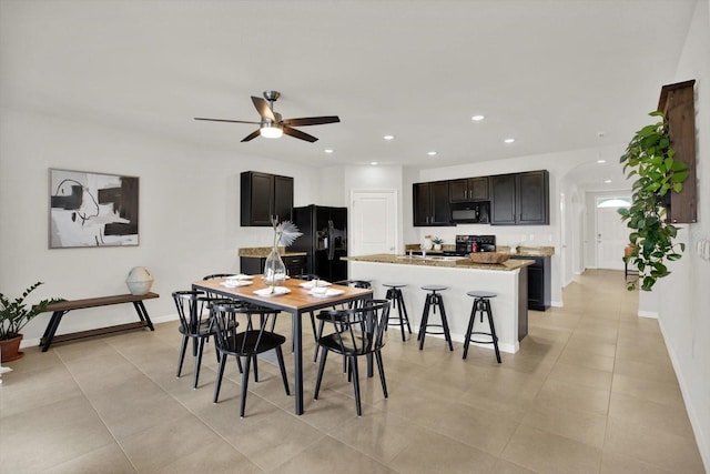 tiled dining space with ceiling fan