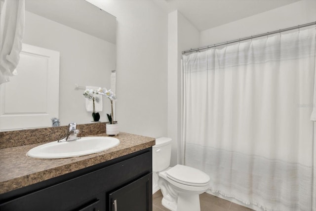 bathroom with vanity, tile patterned floors, and toilet