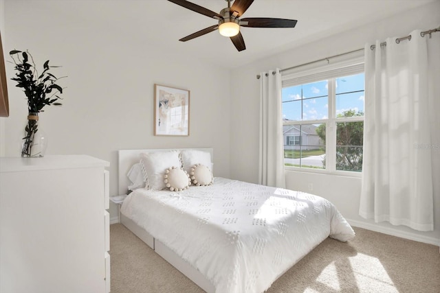 bedroom with light colored carpet and ceiling fan