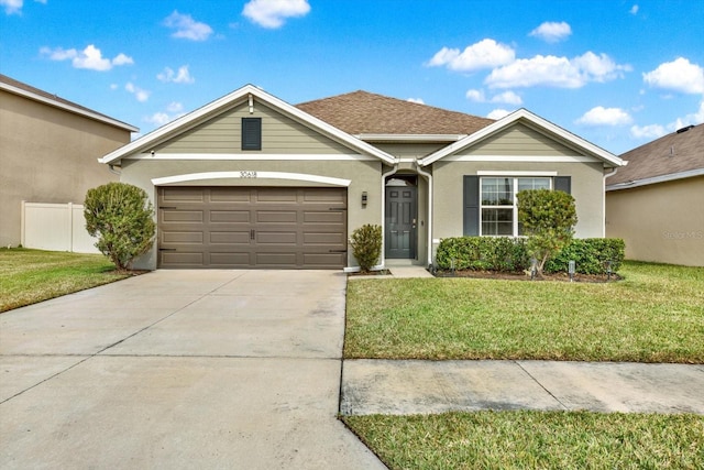 single story home with a garage and a front yard