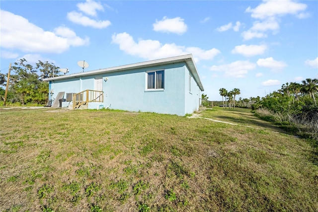 rear view of property featuring a lawn