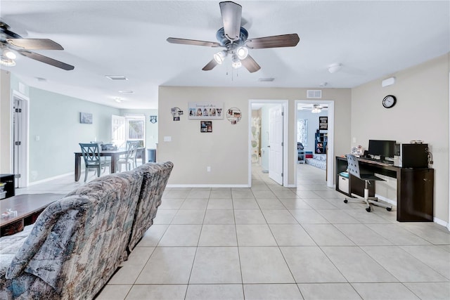 living room with ceiling fan and light tile patterned floors