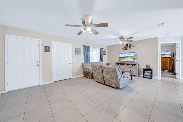 tiled living room with ceiling fan