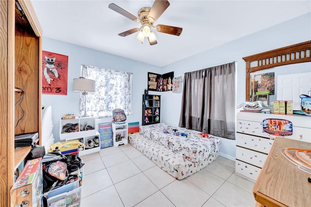 bedroom featuring light tile patterned flooring, ceiling fan, and a closet