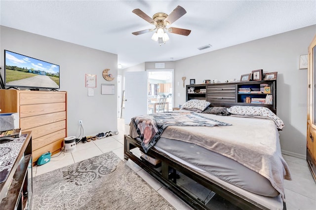 tiled bedroom featuring ceiling fan