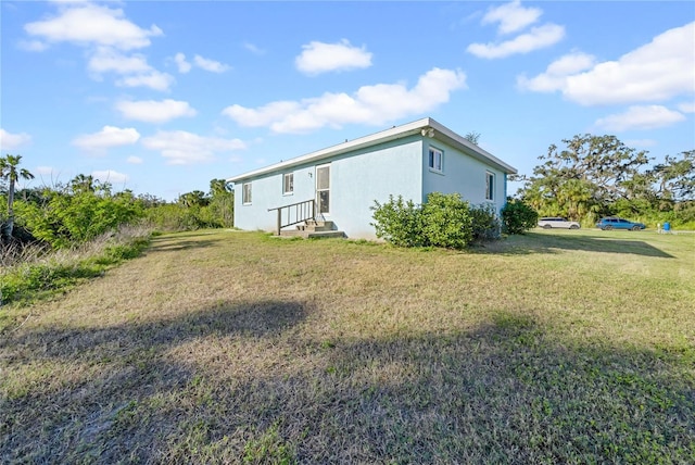 rear view of house with a yard