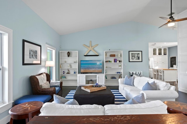 living room featuring vaulted ceiling, wood-type flooring, and ceiling fan