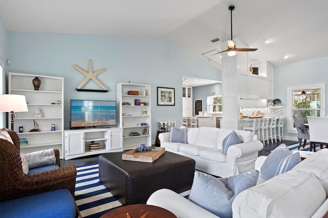 living room with hardwood / wood-style flooring, vaulted ceiling, and ceiling fan