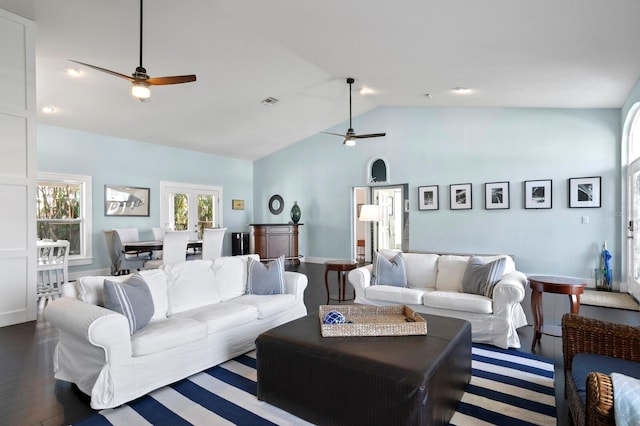 living room featuring dark wood-type flooring, high vaulted ceiling, and ceiling fan