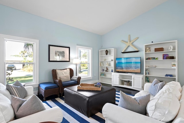 living room with vaulted ceiling and a healthy amount of sunlight