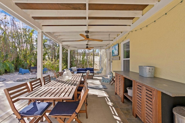 view of patio featuring exterior bar, an outdoor hangout area, and ceiling fan