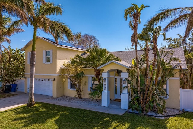 view of front of property featuring a garage and a front lawn