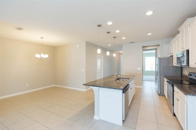 kitchen with stainless steel appliances, a kitchen island with sink, white cabinets, and a sink