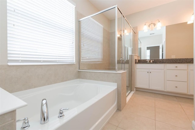 full bath featuring tile patterned flooring, vanity, a shower stall, and a bath