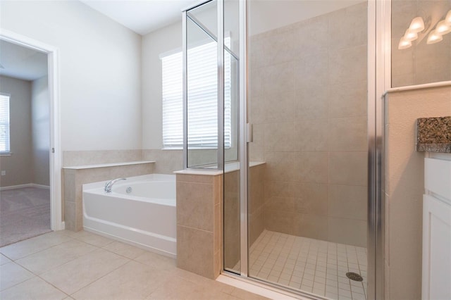 bathroom featuring a wealth of natural light, a garden tub, a shower stall, and tile patterned floors