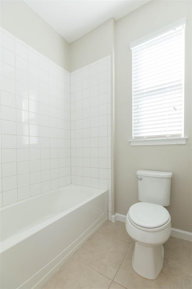 full bath featuring toilet, baseboards, shower / washtub combination, and tile patterned floors