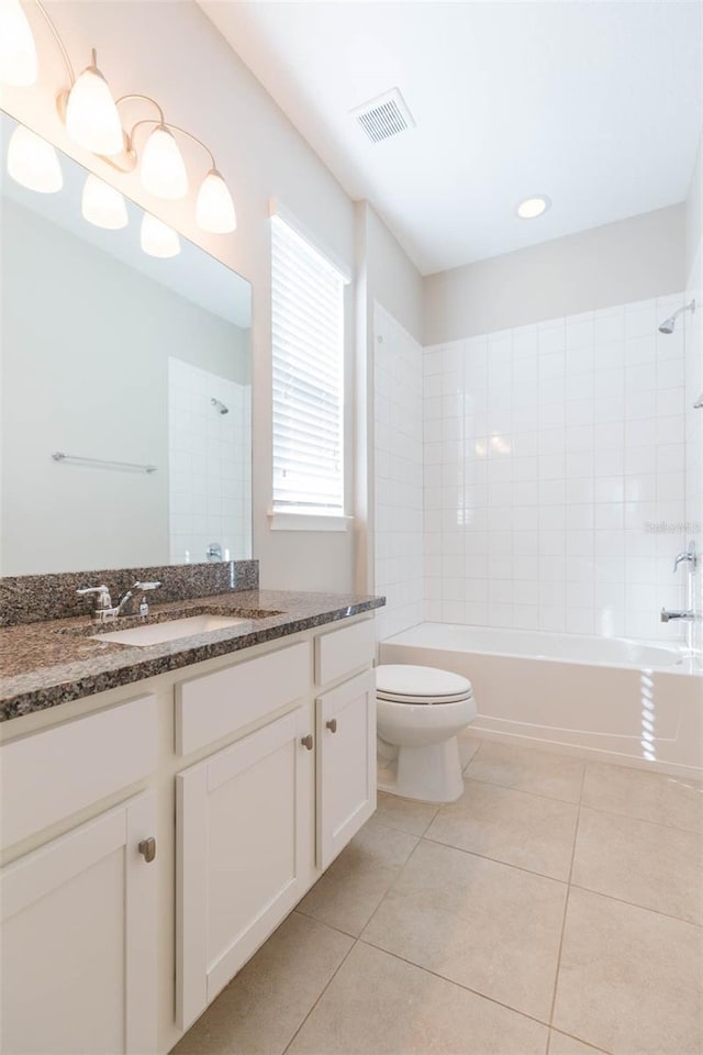 full bathroom with visible vents, toilet, tile patterned floors, tub / shower combination, and vanity