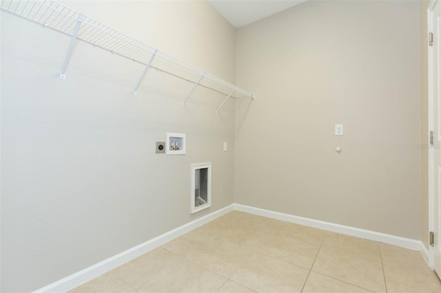 clothes washing area featuring hookup for a washing machine, laundry area, baseboards, tile patterned floors, and electric dryer hookup