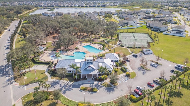 birds eye view of property with a water view and a residential view