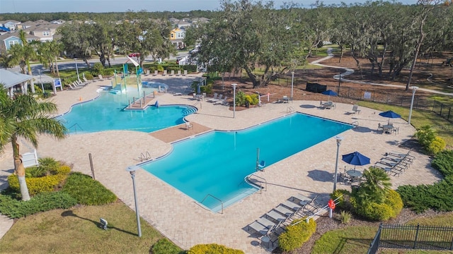 pool featuring fence and a patio