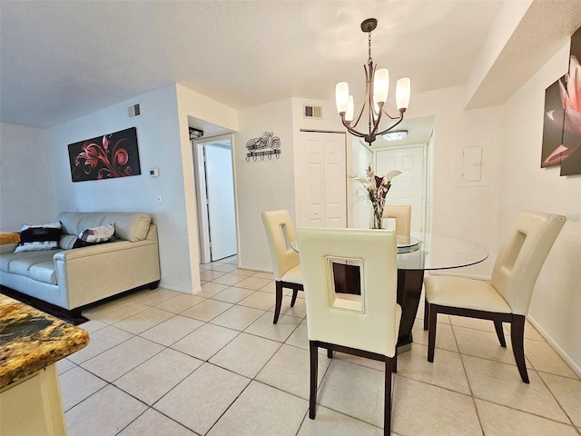 dining space featuring a notable chandelier and light tile patterned floors