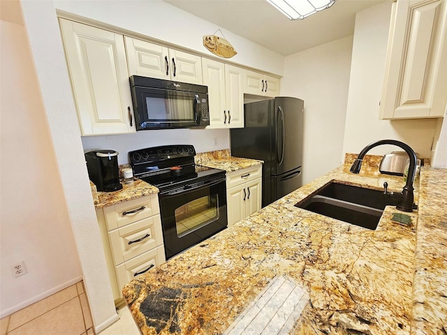 kitchen featuring light tile patterned floors, light stone countertops, sink, and black appliances