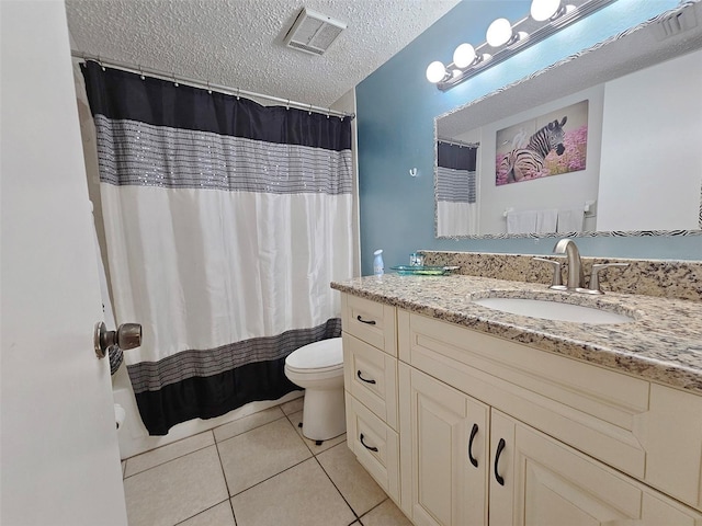 bathroom with vanity, tile patterned floors, a textured ceiling, and toilet