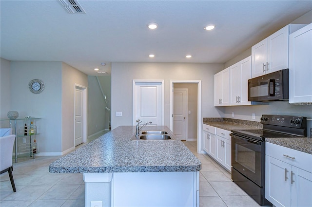 kitchen with sink, black appliances, an island with sink, and white cabinets