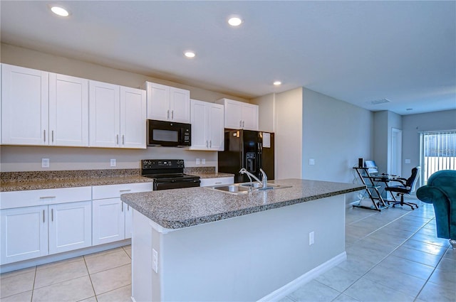 kitchen with white cabinets, sink, a center island with sink, and black appliances