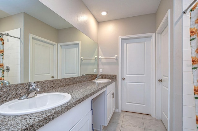 bathroom with vanity, tile patterned floors, and tiled shower