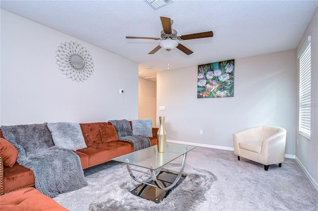 living room with carpet, plenty of natural light, a textured ceiling, and ceiling fan