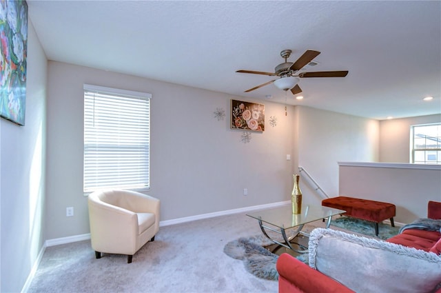 living room featuring light carpet and ceiling fan