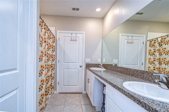 bathroom featuring tile patterned flooring and vanity