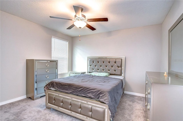 carpeted bedroom with a textured ceiling and ceiling fan