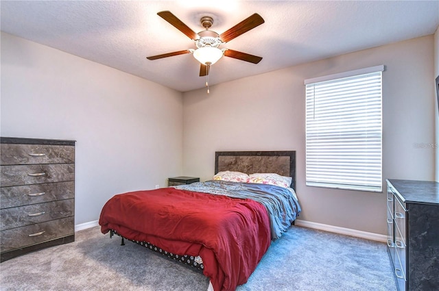 carpeted bedroom with a textured ceiling and ceiling fan