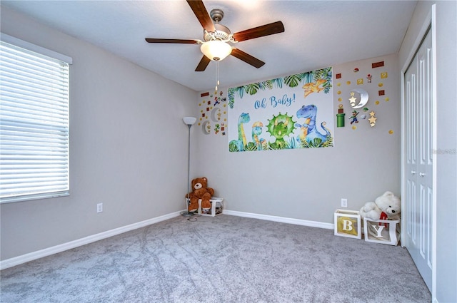 empty room with carpet floors and ceiling fan