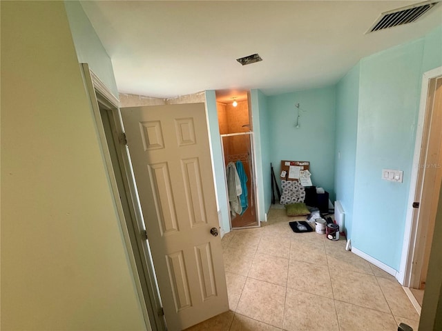 hall featuring light tile patterned floors