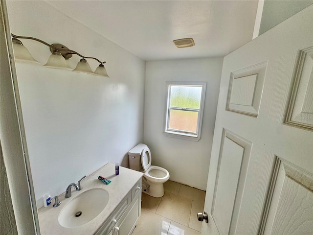 bathroom with vanity, tile patterned flooring, and toilet