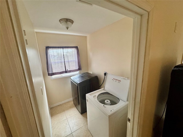 laundry room with separate washer and dryer and light tile patterned floors