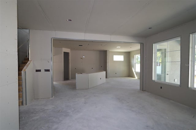 empty room featuring stairway and concrete floors