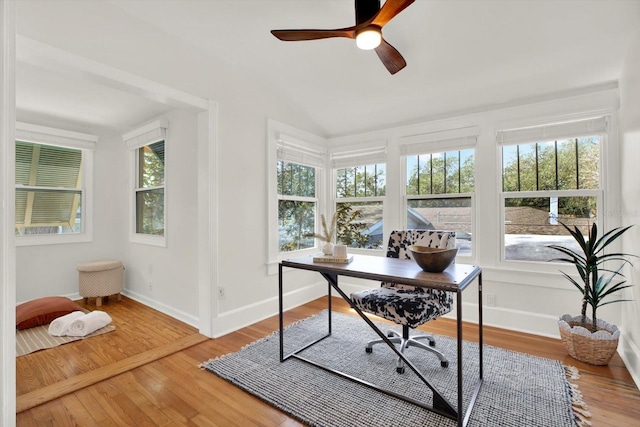 home office with lofted ceiling, hardwood / wood-style floors, and ceiling fan