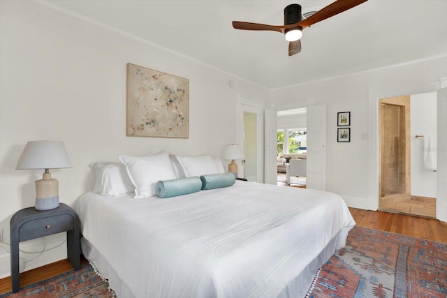 bedroom with dark hardwood / wood-style flooring and ceiling fan