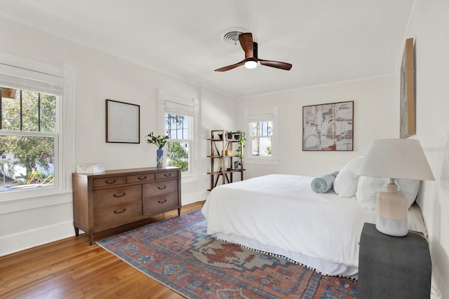 bedroom with ceiling fan and light hardwood / wood-style floors