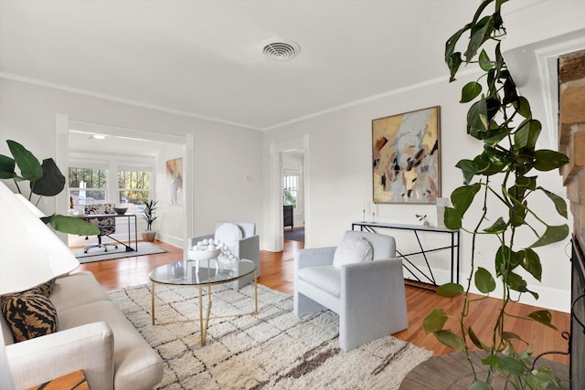 living room featuring wood-type flooring and ornamental molding