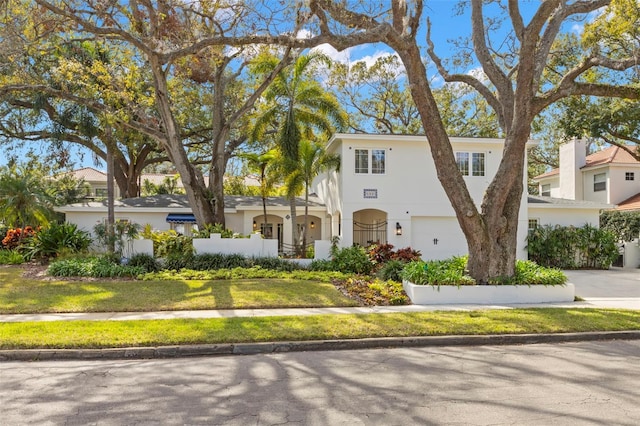 view of front of property with a garage and a front yard